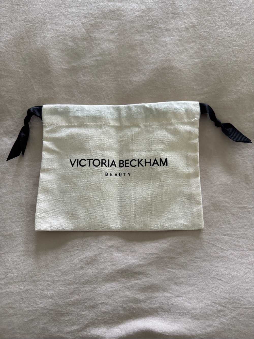 NWOT Victoria Beckham Beauty Ivory Drawstring Pouch with Black Ribbon Closure